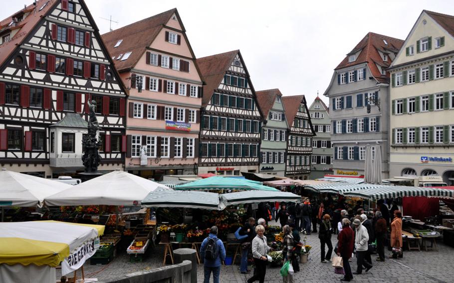 An outdoor farmers market fills the town square in Tübingen, Germany, on a Friday afternoon. There is also an annual Christmas market held in the square. 
