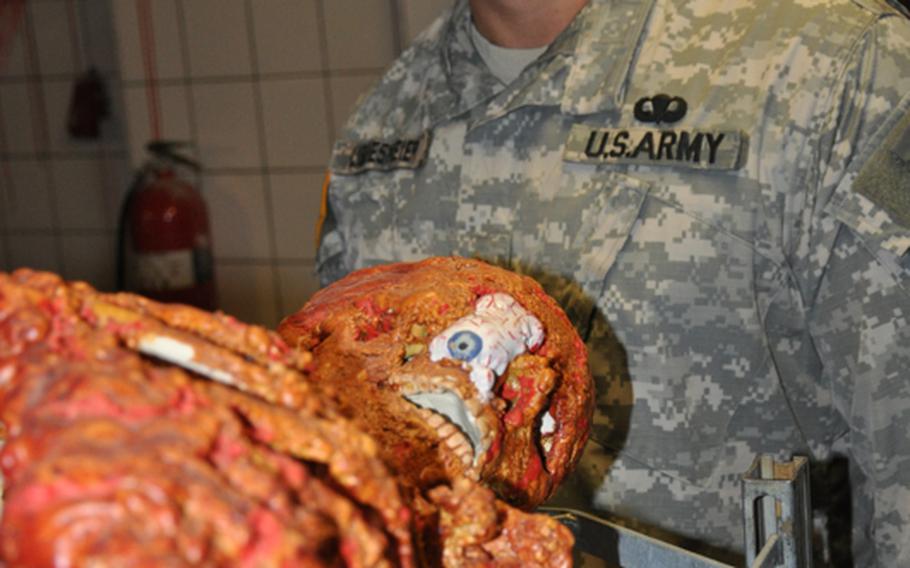 Maj. Jon Libbesmeier, a dentist in Schweinfurt, Gerrmany, and a Halloween enthusiast, stands by one of his many creations at his haunted house on Conn Barracks in Schweinfurt.