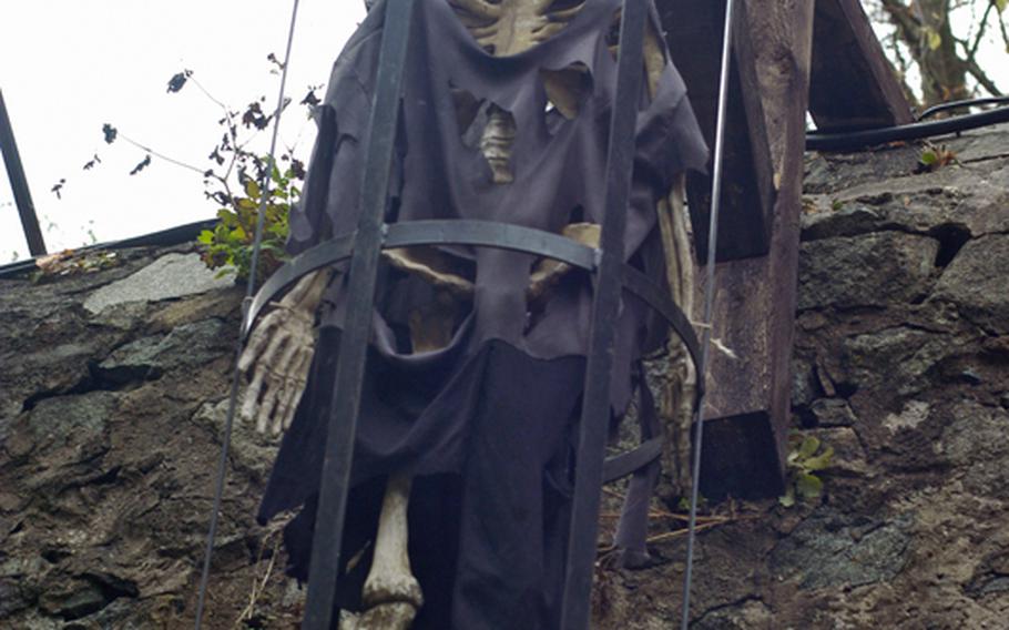 A skeleton looks down on visitors from a cage at  Burg Frankenstein. Parents who want to bring their kids should plan on attending the festivities on a Sunday, where all the monsters are friendly.