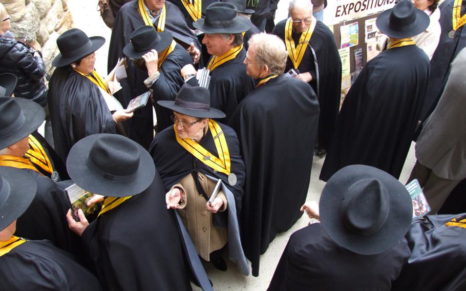 People in the truffle business dress in ceremonial garb to gather before the start of the truffle market in Richerenches, France.