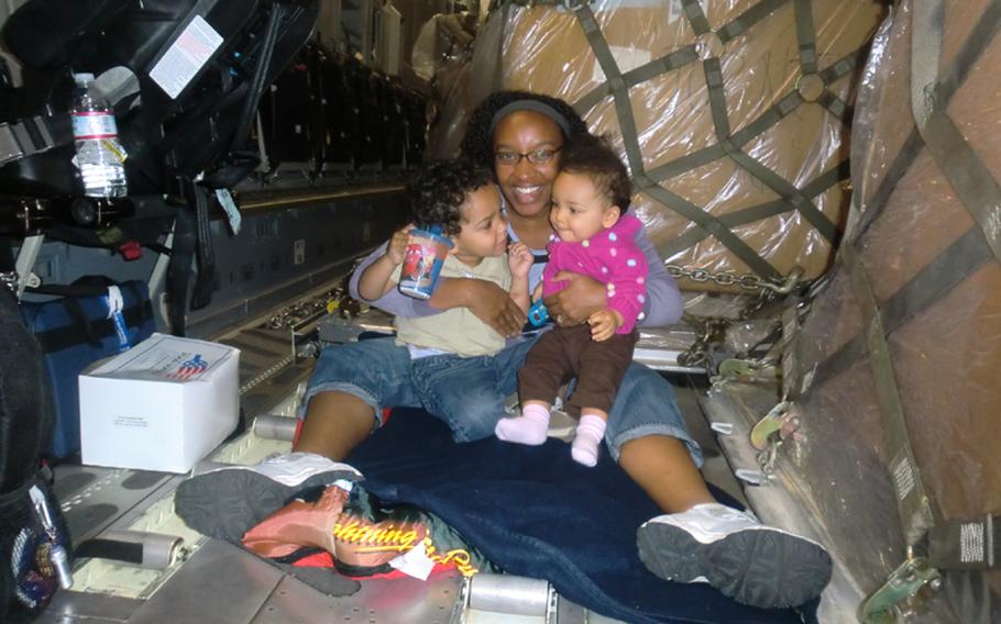 Leslie Wightman gets cozy with son Dallin, left, and daughter McKenna during their space-A flight from Japan to the U.S. aboard a C-130 aircraft.