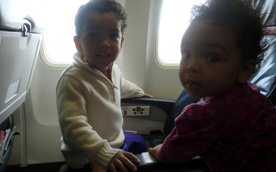 Three-year-old Dallin Wightman, left, and 10-month-old McKenna Wightman pose in their seats before deplaning the Patriot Express at Yokota Air Base, Japan.