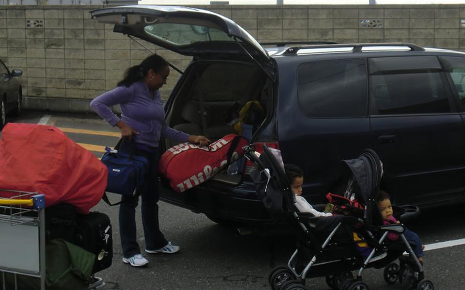 Leslie Wightman loads luggage into the car following the family's space-A flight from the U.S. to Japan aboard the Patriot Express Boeing 757.