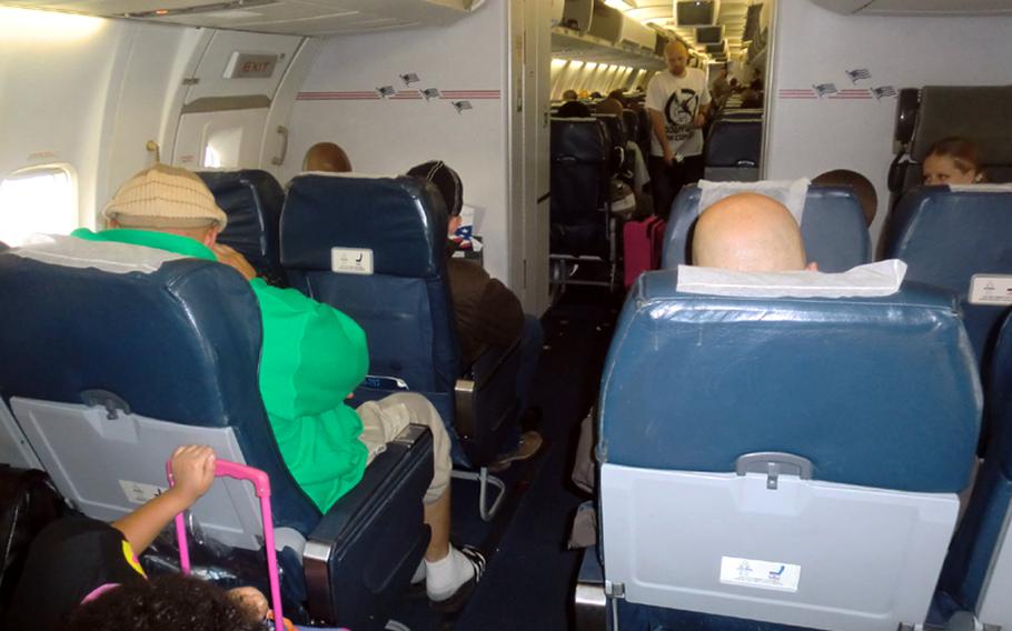 Space-A passengers prepare to deplane the Patriot Express after landing at Yokota Air Base, Japan.