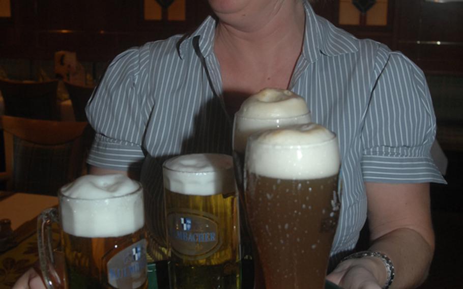 Waitress Jana Slanska delivers a tray of cold beer to guests at Gasthof Andreas Hösl Zum Stich'n. Kulmbacher's is the preferred brew of most patrons.