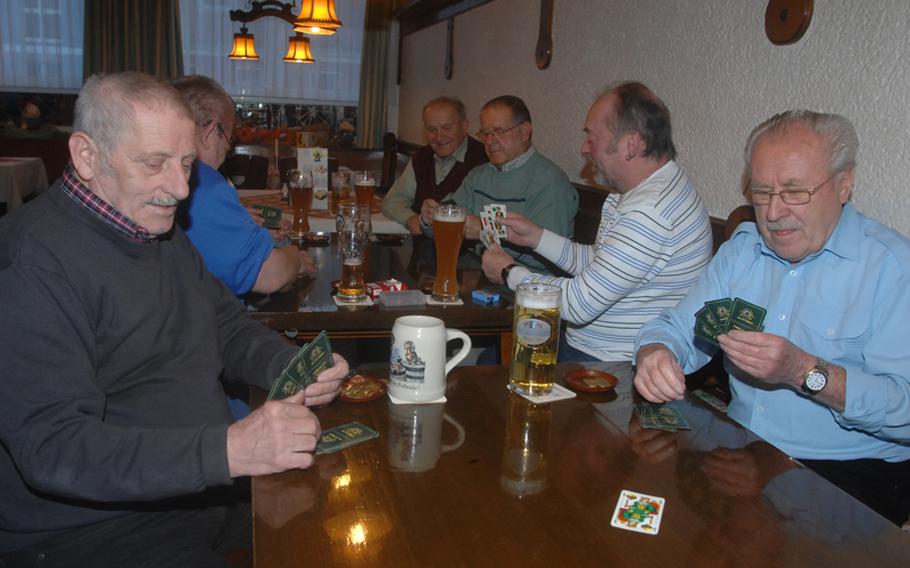 Local Bavarians play cards at the 'Stammtisch' at Grafenwöhr's Gasthof Andreas Hösl Zum Stich'n on a Sunday. The hotel-restaurant serves primarly Americans, but it is also popular with Germans -- especially those who enjoy a good game of cards.