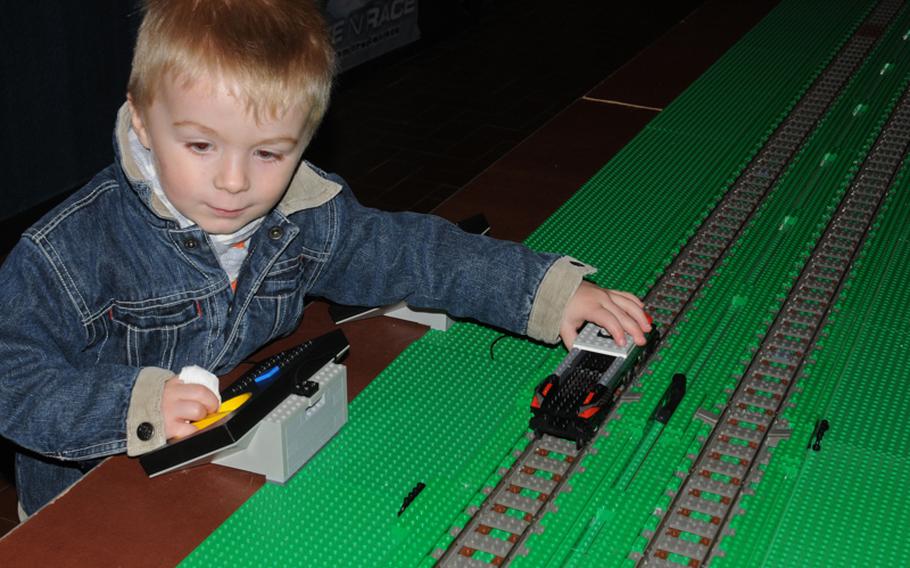 Mika Wegemann,3, of Mainz, Germany proudly puts his  handmade Lego racer on the track to see how fast it can go. The car&#39;s base has an electric motor that is adjusted by the staff operating the exhibit at the Marktkeller in Wiesbaden, Germany.