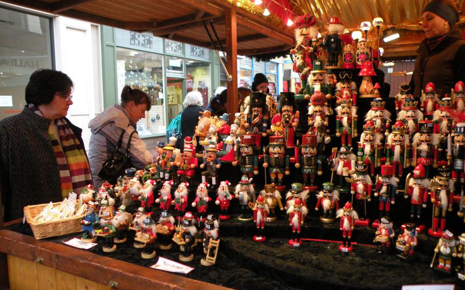 Shoppers browse a craft stand full of decorative nutcrackers and Christmas ornaments at the 2009 Christmas market in Birmingham, England.