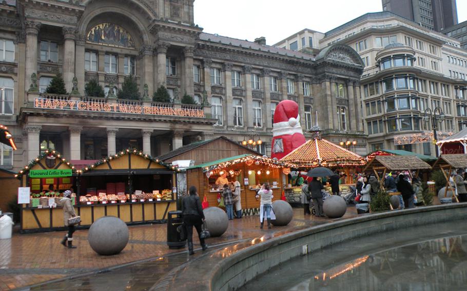 Where are the half-timbered houses?  Stands line the pathway in front of the Birmingham Museum and Art Gallery at the Birmingham Frankfurt Christmas Market in Birmingham, England.