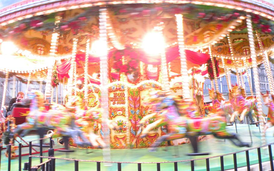 The merry-go-round is one of several attractions for children at the Birmingham Frankfurt Christmas Market in Birmingham, England.