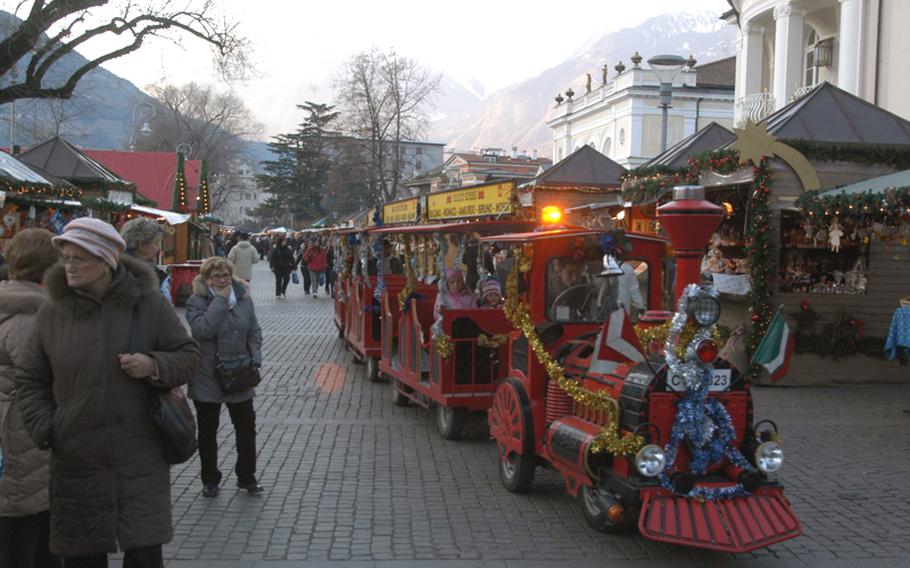 Make way for the holiday train! Shoppers can't get too caught up looking at what's offered in the booths at the Christmas market in Merano, Italy, especially if they're walking in the middle of the pedestrian thoroughfare. The small train is one of many entertainment options designed for the younger crowds at Christmas markets in Trentino Alto-Adige.