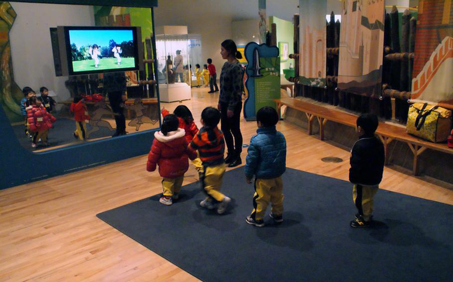 South Korean schoolchildren learn taekwondo at the Children's Museum at the National Museum of Korea.