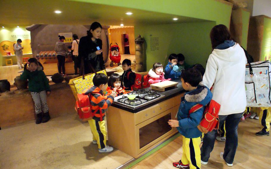 South Korean schoolchildren learn the difference between ancient and modern kitchens at the Children's Museum at the National Museum of Korea.