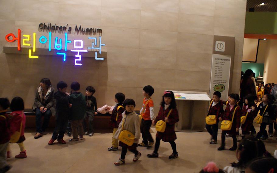 South Korean schoolchildren leave the Children's Museum at the National Museum of Korea.