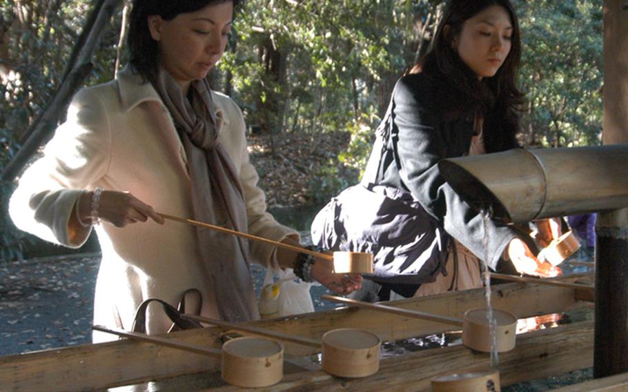 Visitors at Meiji Jingu wash their hands at temizuya, or the water basin, before entering the main shrine. Worshippers are expected to wash their hands and mouths before entering the altar to pray in order to cleanse themselves.