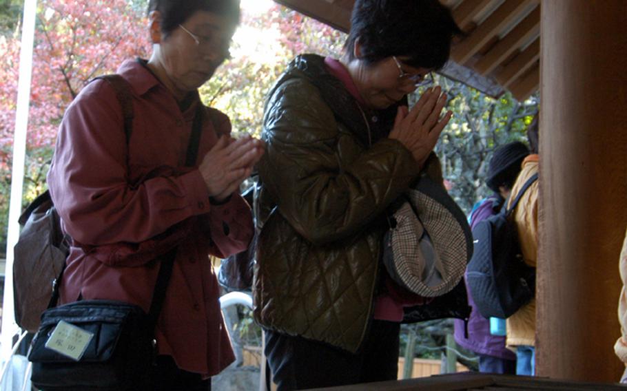 Visitors pray before the altar at Nogi Jinja in Tokyo.