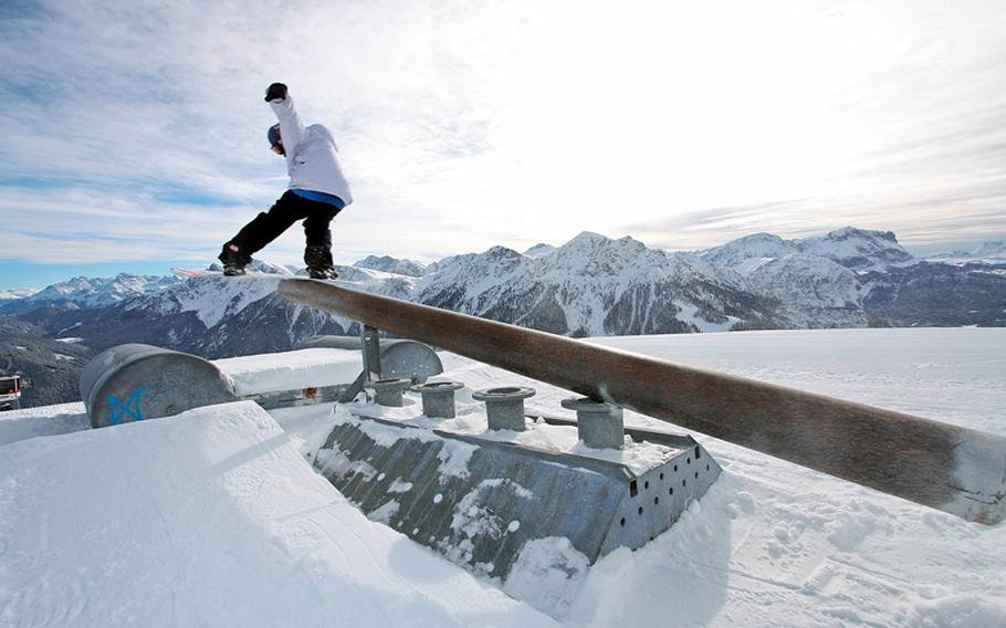 A snowboarder rides a rail at the Snowpark Kronplatz, a snowboard park the size of 10 football fields, at the Kronplatz/Plan de Corone resort in Italy's Dolomites.