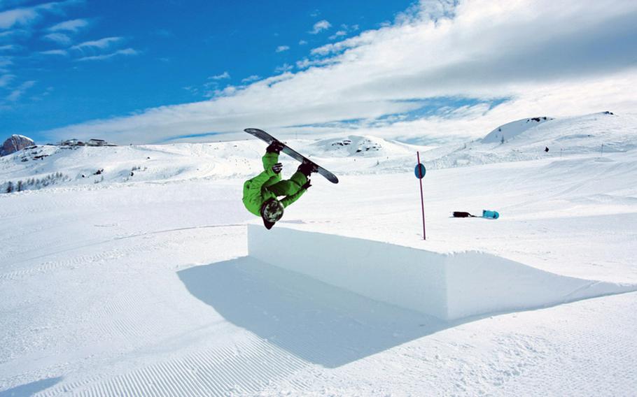 A snowboarder grabs "big air" off one of the jumps at the 20 snowboard parks in Italy's northern Dolomite mountain range.