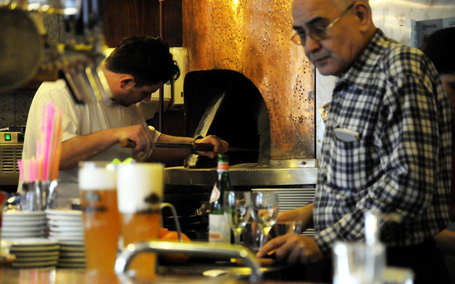 Staff of Pizzeria Il Pomodoro in downtown Stuttgart prepares food during the lunch rush. The pizzeria offers authentic pastas, pizzas and other Italian dishes and gives a good bang for your buck.