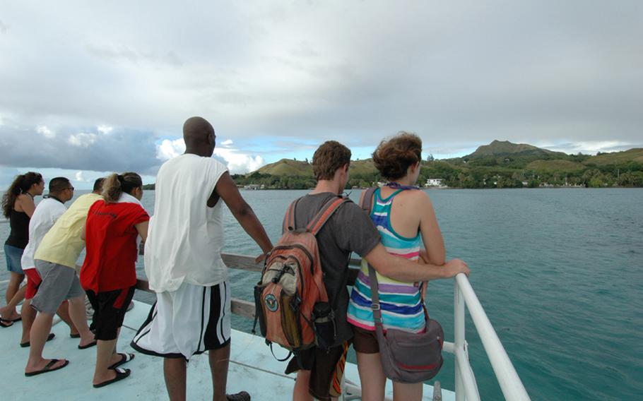 Passengers aboard the Cocos Island Resort boat look out on Guam upon returning from Cocos Island.