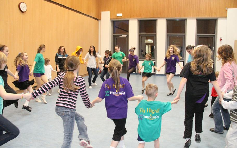 Students and parents try their hands and feet at Irish dancing, led by members of  the Tir Na Nog school based in Kaiserslautern during the Landstuhl Elementary-Middle School's third annual Family Wellness Night on Feb. 10.