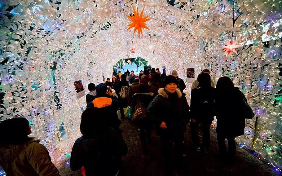 Visitors to the Sapporo's annual winter festival walk through a tunnel of 'snowflakes.'