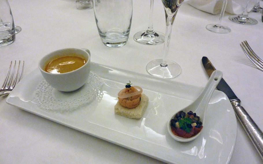 A trio of amuse-bouches -- from left, an espresso-size cup of fish soup, salmon mousse, and lentils on bacon -- started the dinner at the Au Cheval Blanc in Niedersteinbach, France.