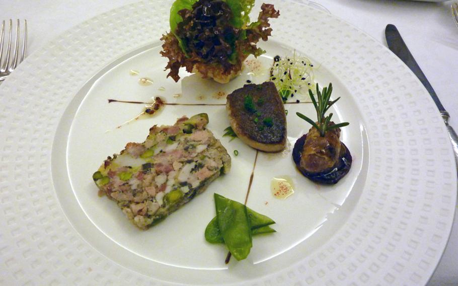 Terrine of  rabbit, left, served with a bouquet of lettuce, fried rabbit fat and a small rabbit sausage was an appetizer at the Au Cheval Blanc in Niedersteinbach, France.