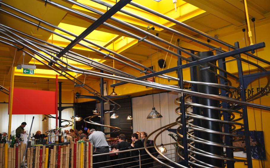 A roller coaster of rails carries food from the kitchen to individual tables, making customers feel like they are inside the belly of a machine while eating at the futuristic restaurant 's Baggers near Nuremberg.