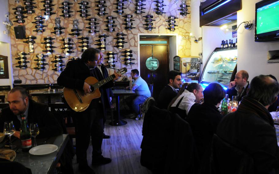 Singers, called "i posteggiatori," visit restaurants to serenade, take requests and offer guests a tuneful taste of Neapolitan music. They add a traditional sound to go along with traditional food in this restaurant with the modern decor.