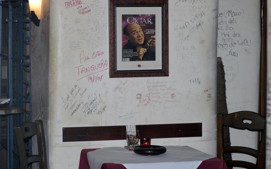 Hollywood celebrity cigar smokers are a prominent decoration at the Cigar Bar Lounge in Frankfurt, Germany.  Guests are also encouraged to write or draw on the walls during their visit.