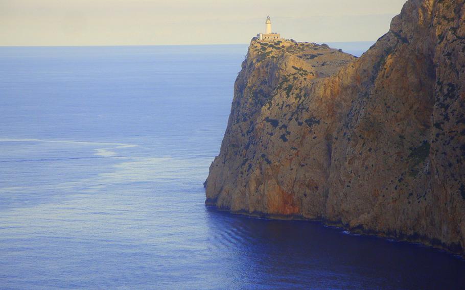In Majorca, lighthouses stand sentinel atop sheer cliffs, which drop straight down to the blue Mediterranean Sea.