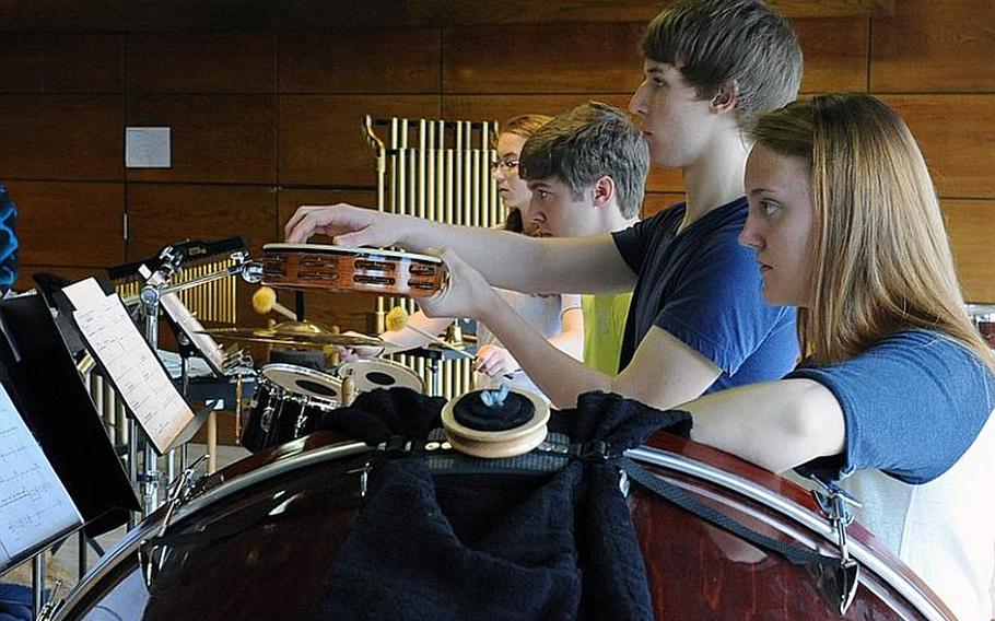 Percussionists Micalea Young, Mitchell Petersen, Phillip McElveen and Theresa Bolan wait their cue during Honors Band rehearsals on Wednesday. Petersen is from Brussels, Belgium, while the others go to Ramstein High School in Germany. 