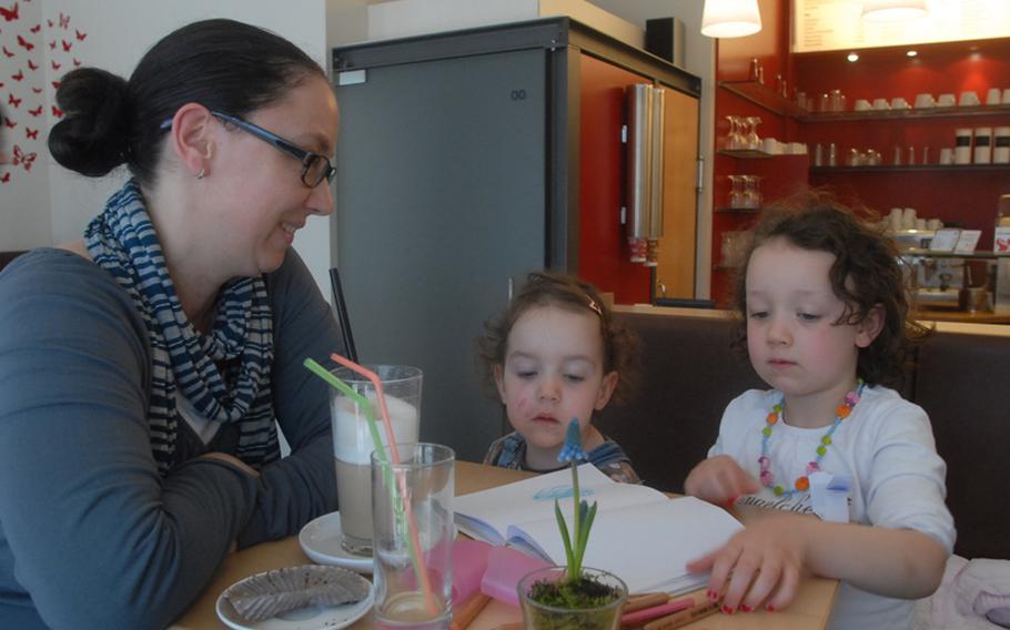 Michaela Schläfer and her two daughters, Paula, center, and Emma relax one recent afternoon at MilchundZucker, a coffee shop in downtown Kaiserslautern. The mom and her daughters frequent the coffee bar at least a couple of times a week. The shop draws a wide range of people, including a handful of Americans who come to enjoy the coffee and shop's free Internet access.