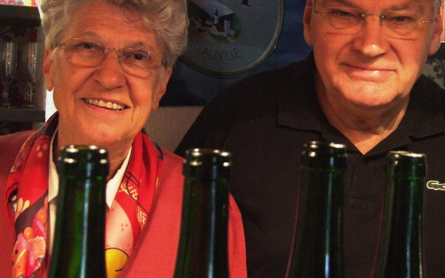 Simone and Pierre Sipp pose with some of their wares at the winery Louis Sipp, founded by Pierre's father, Louis, in Ribeauville, France. Simone says Alsatian white wines are fruitier than those made elsewhere in France.  She and her husband now run the winery.