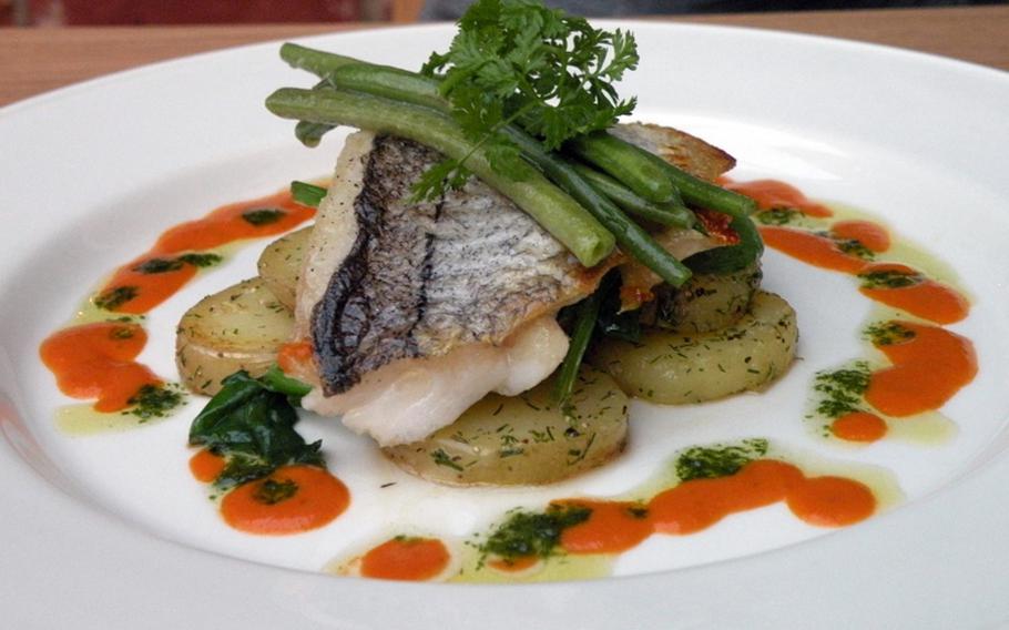 An appealing baked haddock with dill-sauteed potatoes, buttered spinach and tomato-butter sauce from The White Horse in Brancaster Staithe, Norfolk.