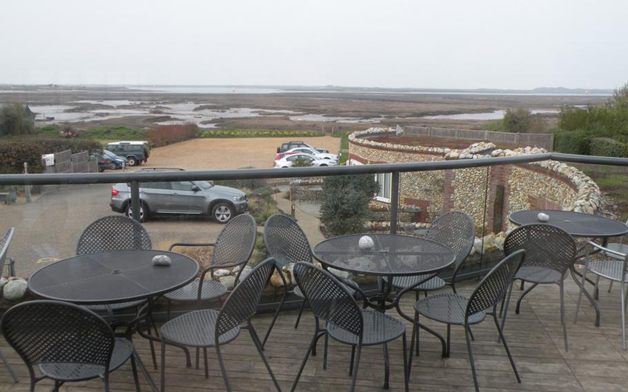 The view from the sun-deck terrace in the rear of The White Horse restaurant in Brancaster Staithe, Norfolk, includes marshland and parts of the Norfolk Coastal Path that borders the North Sea.