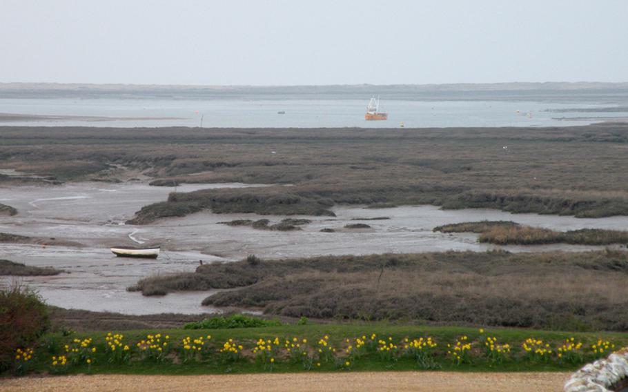 The marshland and Norfolk Coastal Path is visible from The White Horse restaurant in Brancaster Staithe, Norfolk.