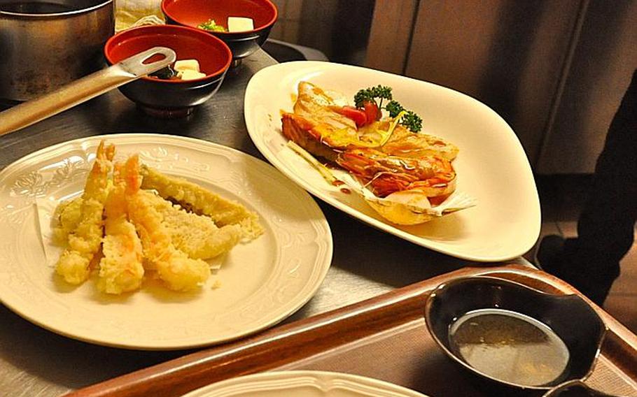 Two of the appetizers offered at Brasserie Hashimoto: On the left is tempura,  lightly battered shrimp and vegetables; at right is a variety of grilled items, including fresh fish, vegetables and some noodles.