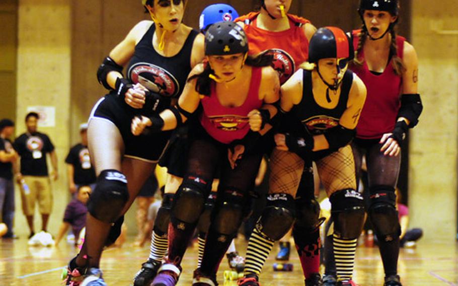 Kokeshi Roller Derby team members push and shove their way through an event May 14 on Okinawa, Japan.