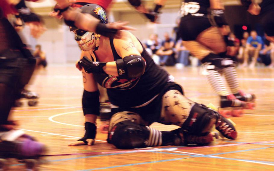Anita "Alma Haters" Walker takes a tumble during the Spring Roll roller derby at Comprehensive Park on May 14.