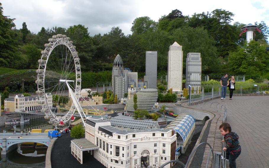 A child gets a close look at models of London&#39;s Waterloo Station and the London Eye at Miniland at Legoland Windsor amusement park. Miniland is home to nearly 40 million of the 55 million Lego blocks at the theme park.