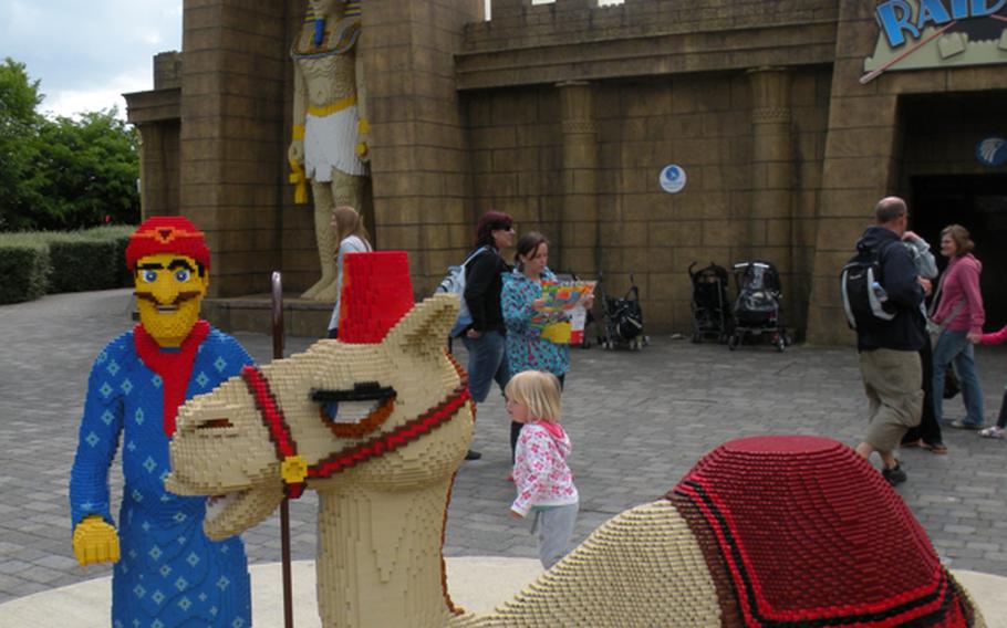 A Lego camel and its keeper appear in front of a large Egyptian statue -- also made out of Lego blocks -- at Legoland Windsor near London.