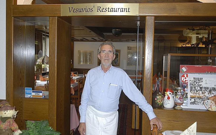 Franco Ammirati stands in front of a sign from his old restaurant, Vesuvio&#39;s, which once was in the basement of the officers&#39; club at Ramstein Air Base. The sign is now displayed at Dino&#39;s, a restaurant which Ammirati has owned with his wife, Christiane, since 1970, in Hohenecken, Germany.
