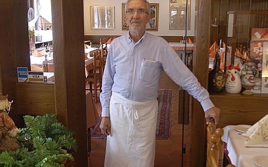 Franco Ammirati stands in front of a sign from his old restaurant, Vesuvio&#39;s, which once was in the basement of the officers&#39; club at Ramstein Air Base. The sign is now displayed at Dino&#39;s, a restaurant which Ammirati has owned with his wife, Christiane, since 1970, in Hohenecken, Germany.
