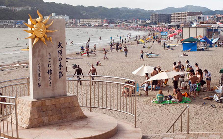 Red umbrellas dot the sand at Zushi Beach in Sagami Bay.