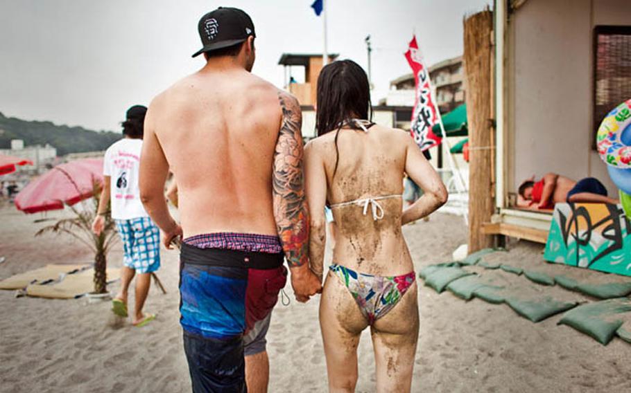 'Girls here love tattoos; they think it's cool,' said David Williams, a petty officer on the USS John S. McCain. Williams spent the day at Zushi Beach with his friends on July 9, 2011.