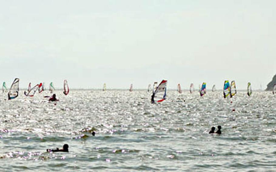 Zushi Beach in Sagami Bay, with its crosswinds and lack of surf is hugely popular with windsurfers.