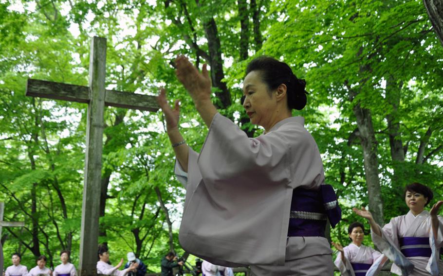 Women from Shingo, Japan, dance around what they call the Tomb of Christ, during a festival in late May.