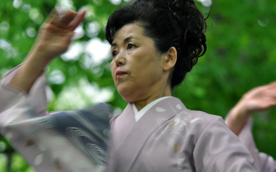 A woman from Shingo, Japan, dances around what local villagers call the Tomb of Christ, during a festival in late May.